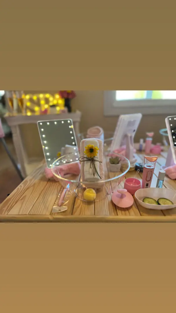 A closeup look of of all kinds of makeup items on a wooden table