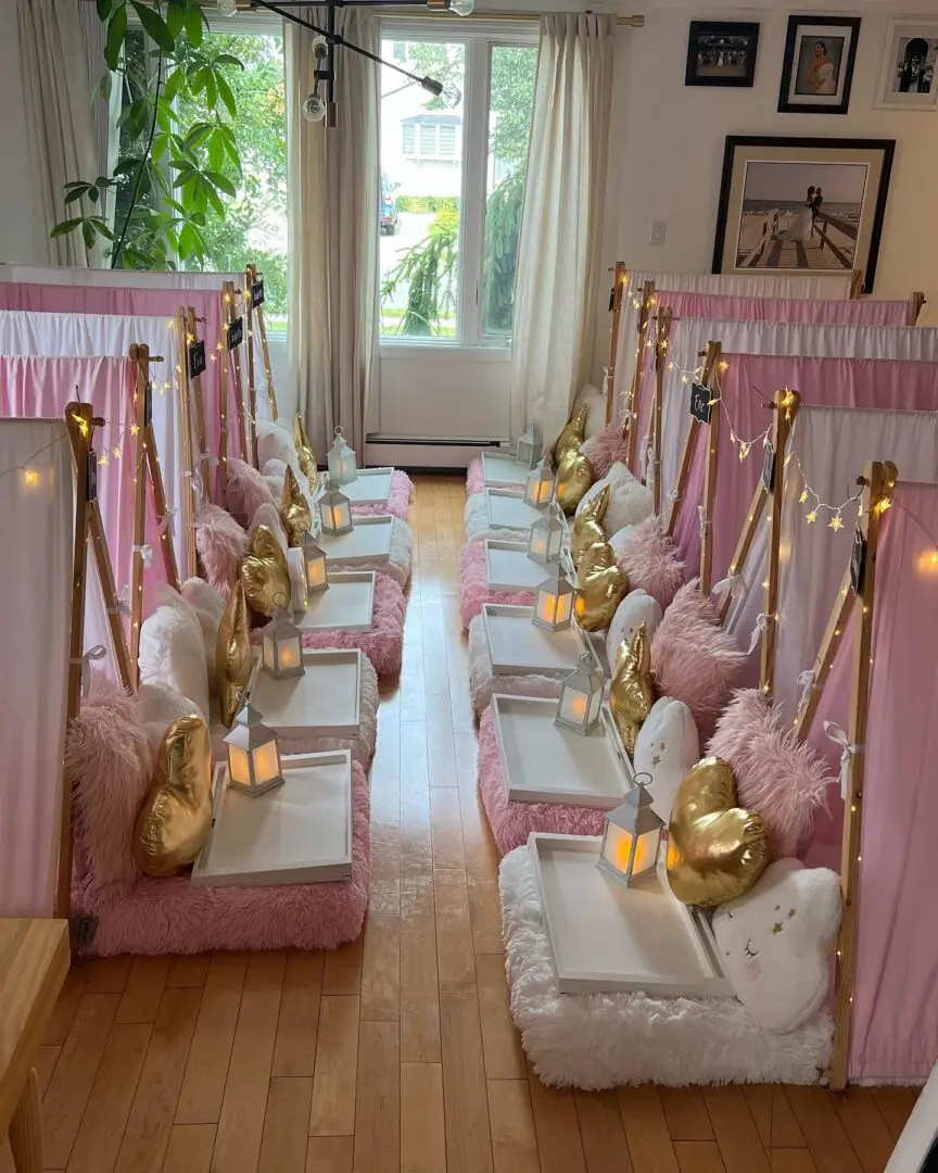 A room filled with pink and white tents and candles.