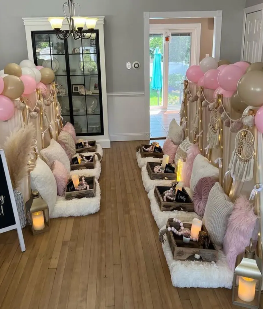 A room filled with balloons and decorations for a baby shower.