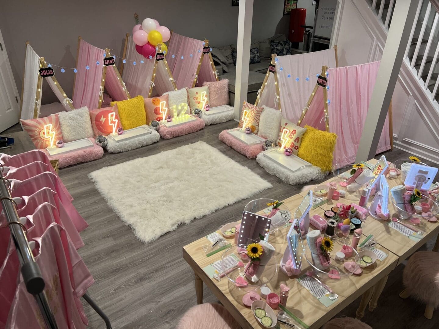 A girl's birthday party with teepee tents and balloons.