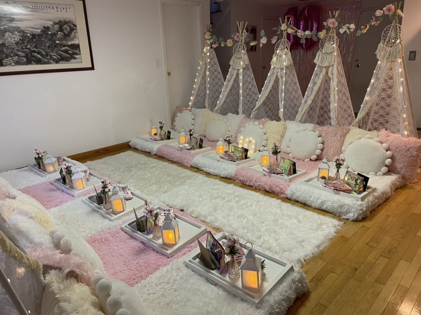 A room filled with pink and white pillows and candles.