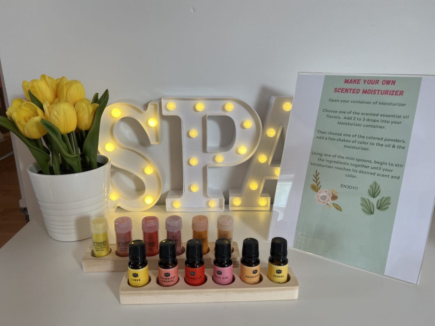 A table with a bottle of nail polish and tulips.