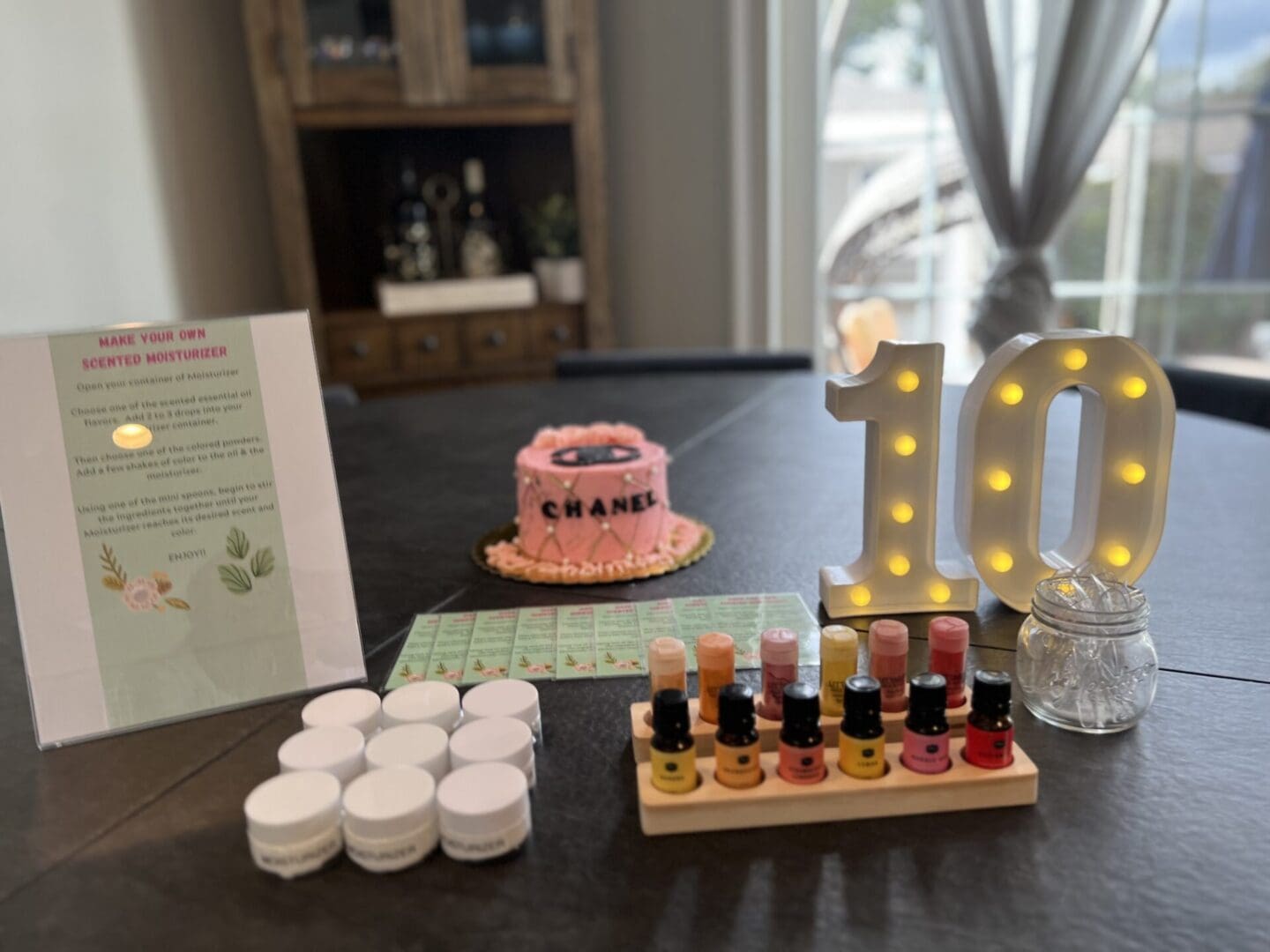 A table with a cake, nail polish, and other items.