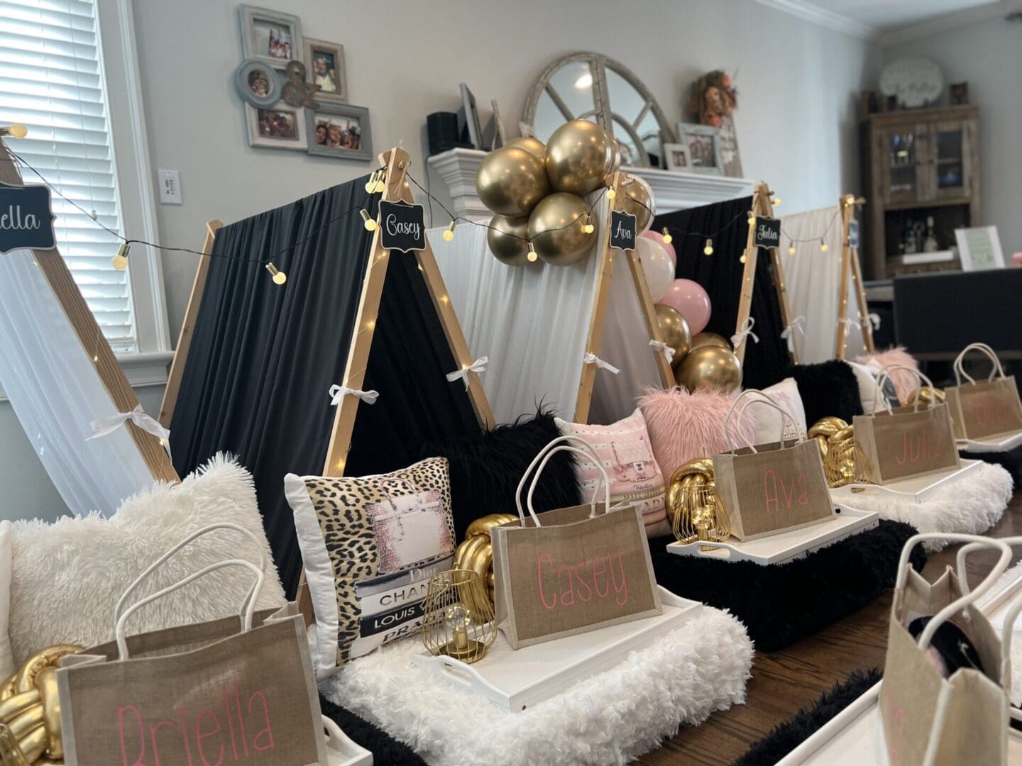 A black and gold birthday party with teepees and balloons.