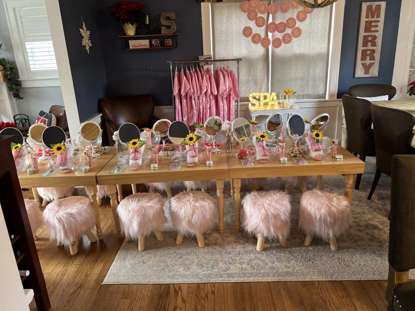A girl's birthday party with a table full of mirrors and stools.