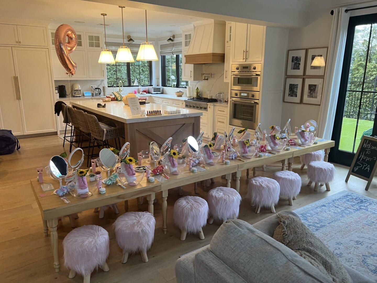 A living room with a table full of pink stools and mirrors.