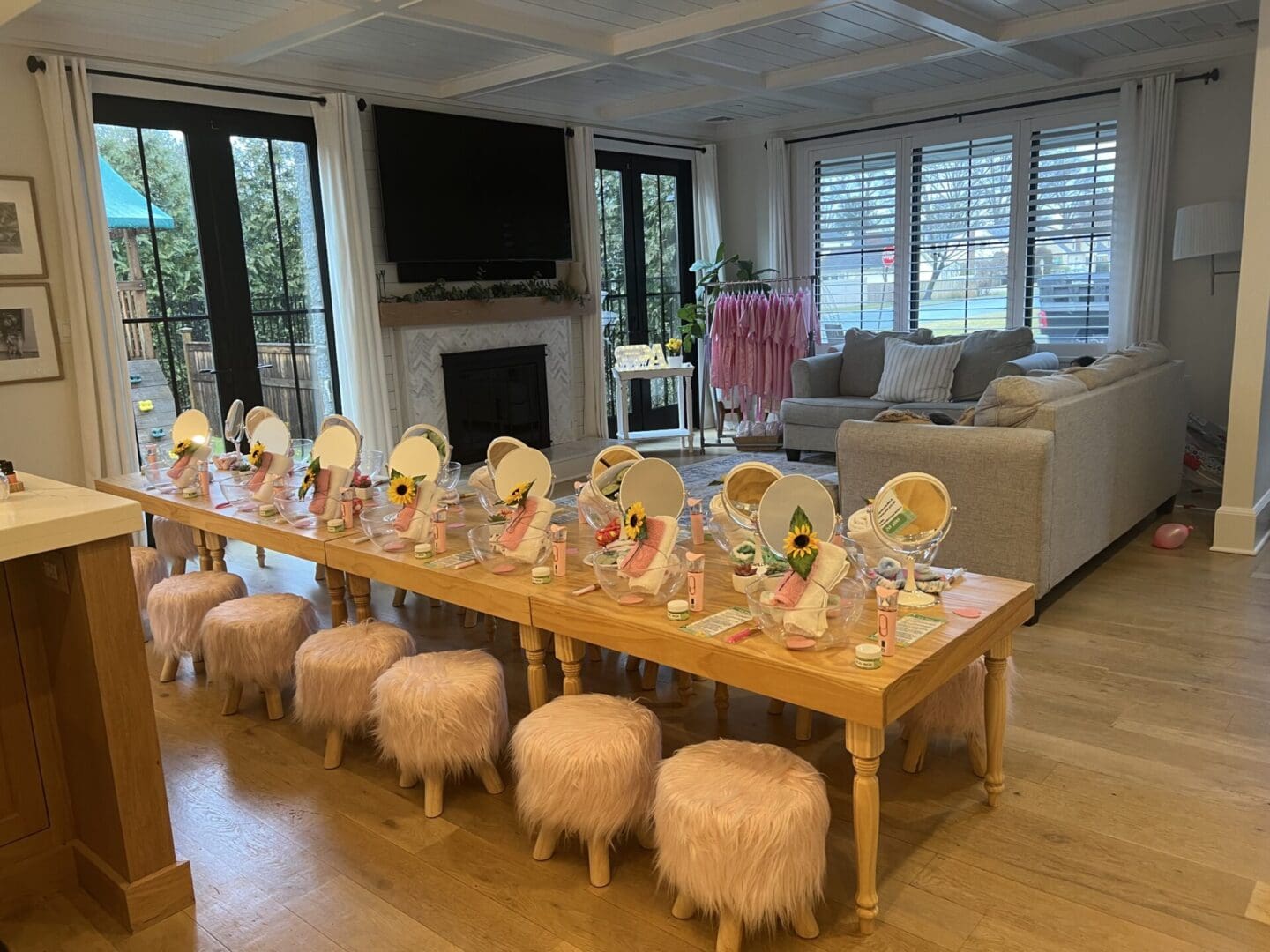 A living room with a table set up for a girl's birthday party.
