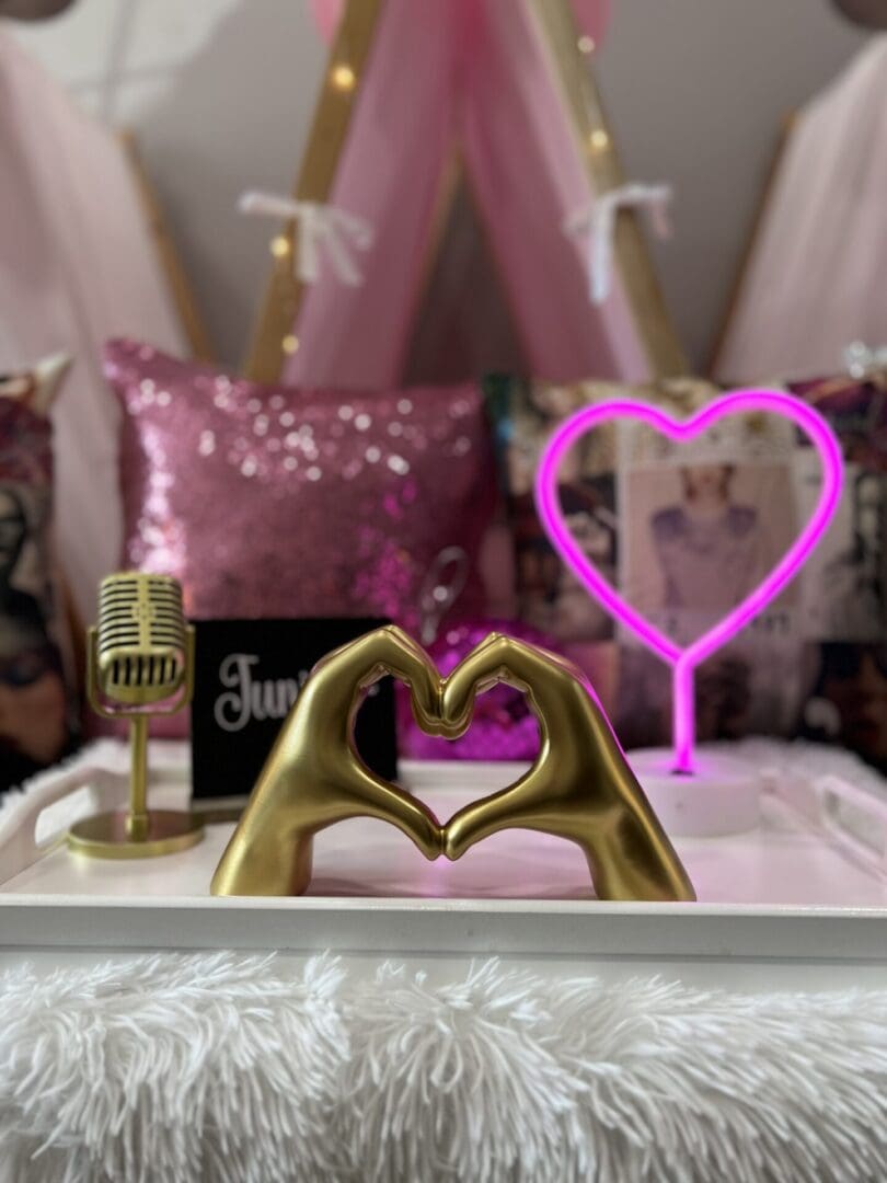 A tray with a gold heart and a microphone.